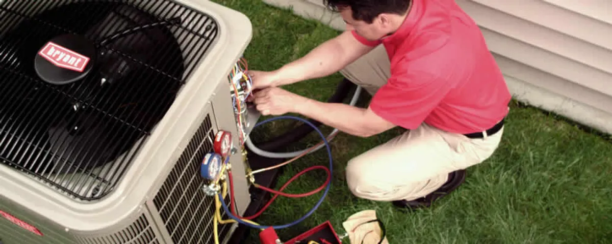 HVAC technician servicing an outdoor air conditioner unit in Oak Park, IL